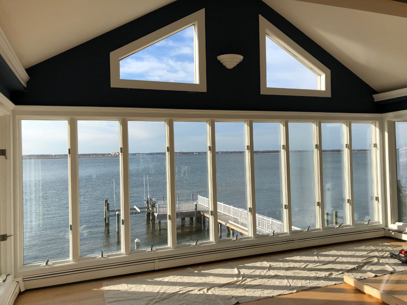 Waterfront sunroom with custom window trim